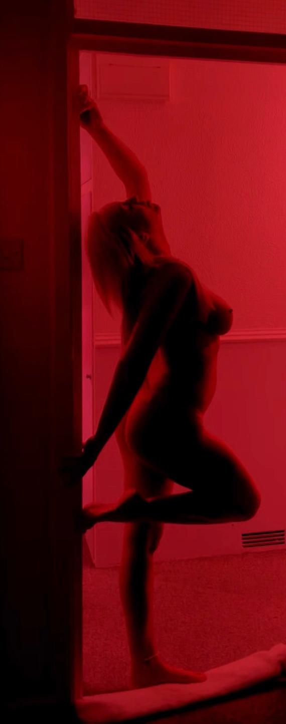 Jessica Fox in crimson light, framed in a doorway
